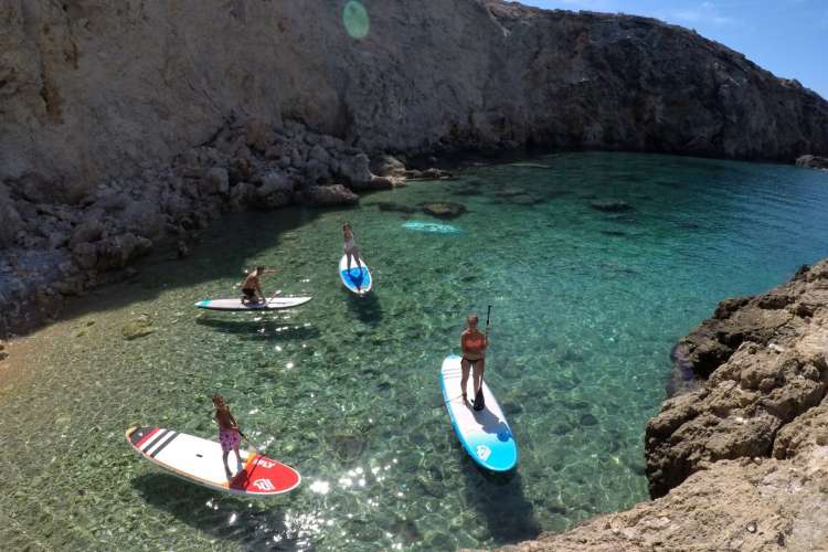 Group-practicing-paddle-surfing-Ibiza
